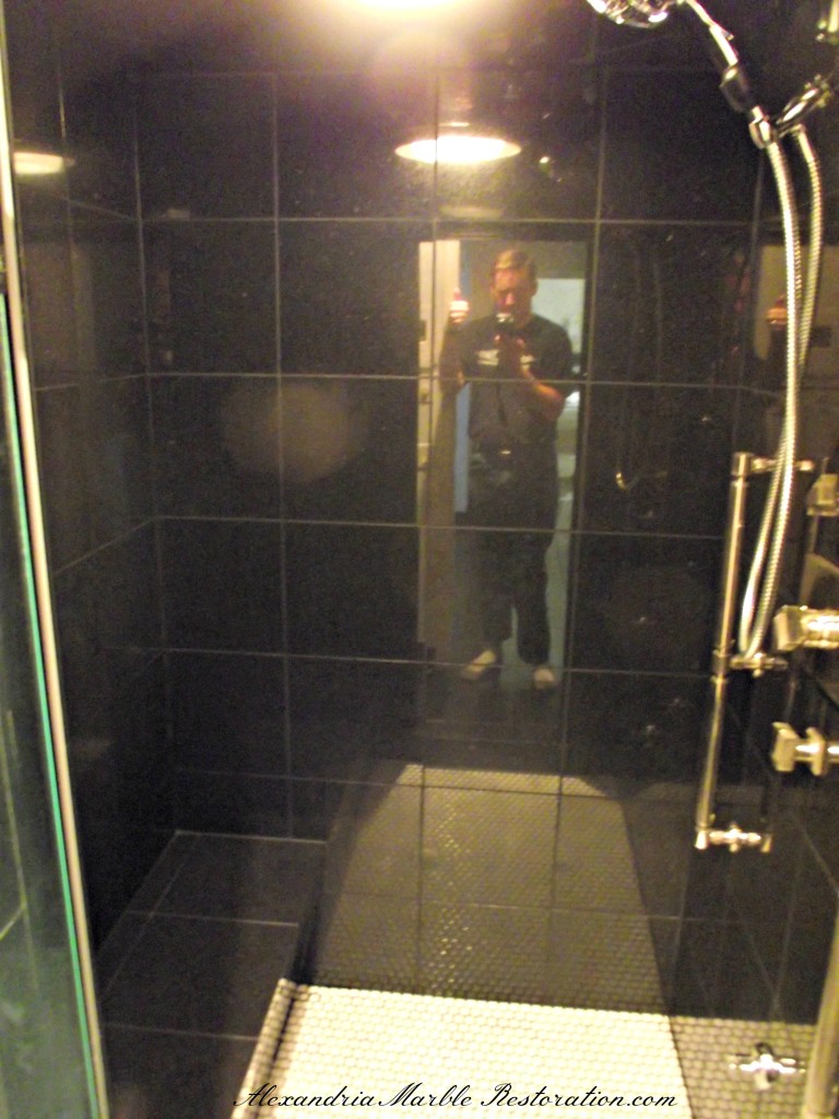 Black marble shower after restoration