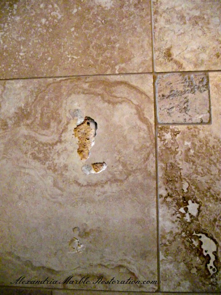 Travertine tile flooring with missing factory filler