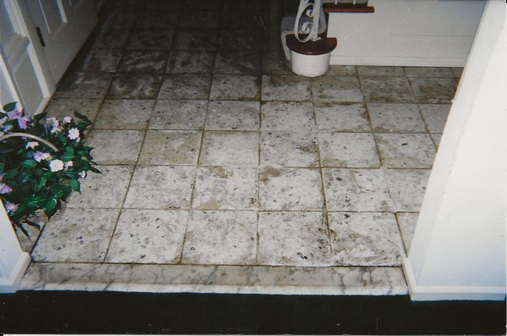 Waxed terrazzo tile flooring before restoration