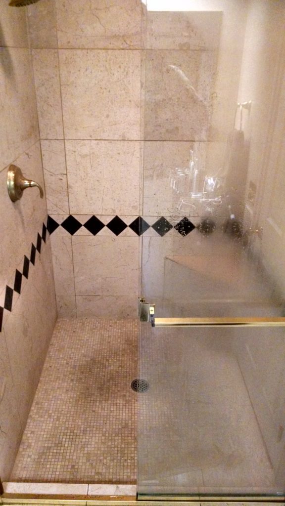 Polished marble shower in need of a full restoration