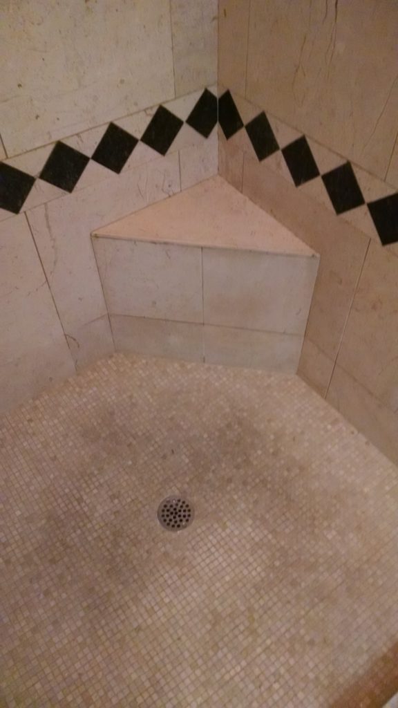 Marble shower with soap and mineral build up