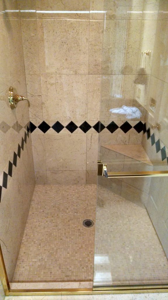 Polished marble shower after a full restoration.