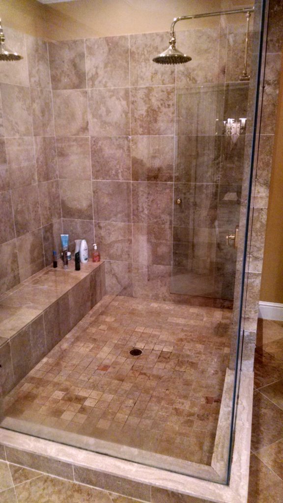Travertine shower before restoration and grout replacement