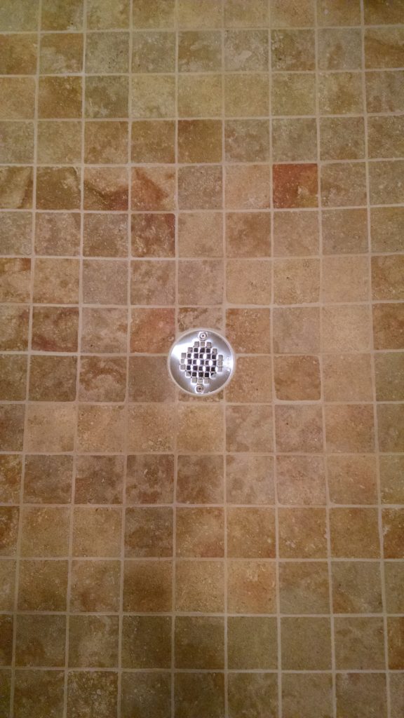 Travertine stone shower after restoration and grout replacement