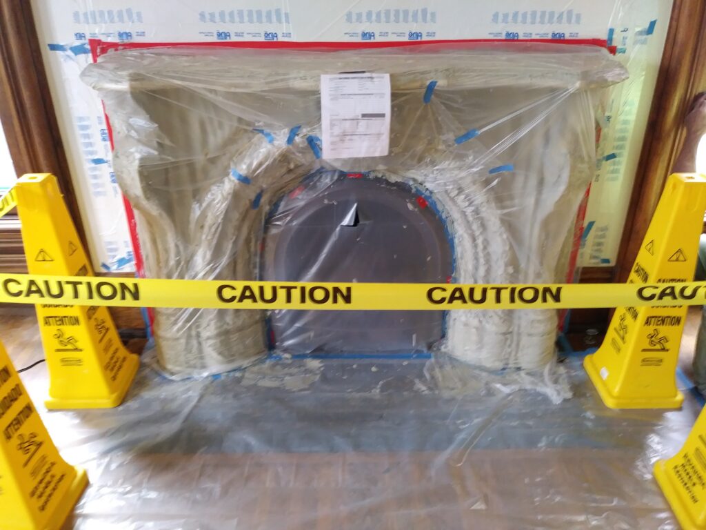 Columbus Club Louis XVI statuary marble fireplace during historical restoration